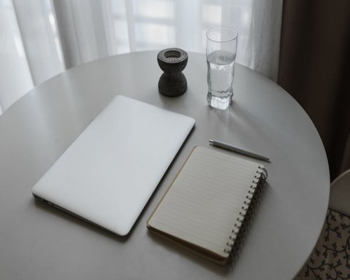 A quiet workspace with a laptop and a notebook